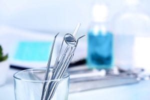 Dentist tools in glass table close up