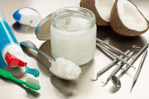 Selection of dentists tools on a stainless steel background with coconut oil, toothpaste, toothbrush and floss-img-blog