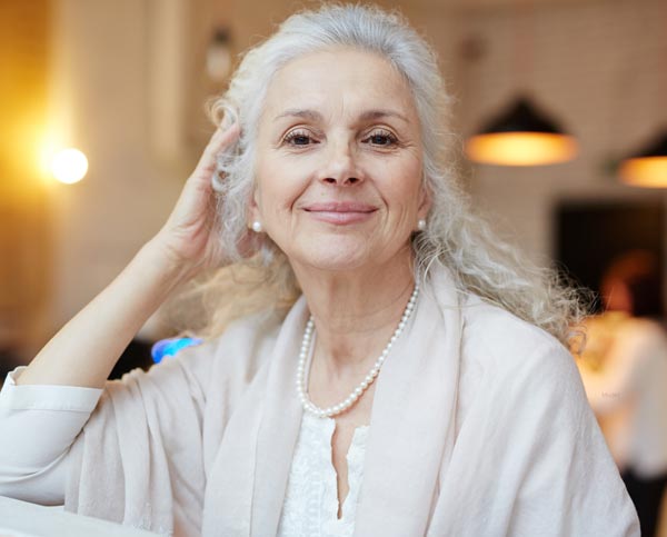 older woman happy dentures from the pali dentist