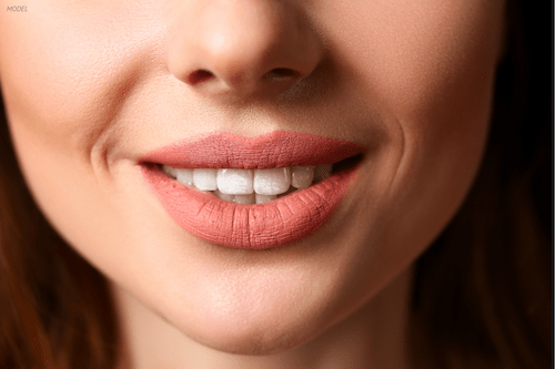 Close-up image of a woman's smile showing upper teeth